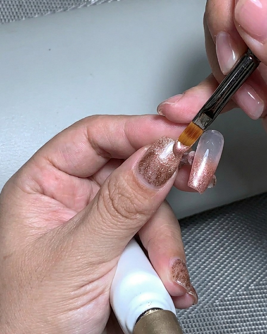 Una mano posta sotto una lampada UV per polimerizzare lo strato di gel strutturale.
