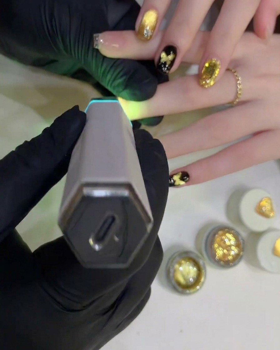 Una lampada UV/LED polimerizza il top coat finale sullunghia completata.