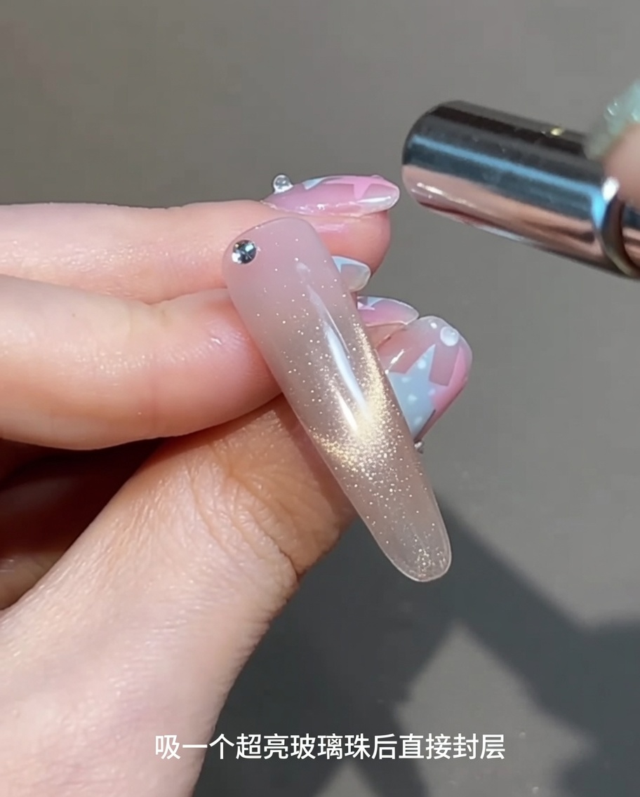 Un magnete cilindrico tenuto parallelamente sopra ununghia con gel bagnato per creare un riflesso scintillante.