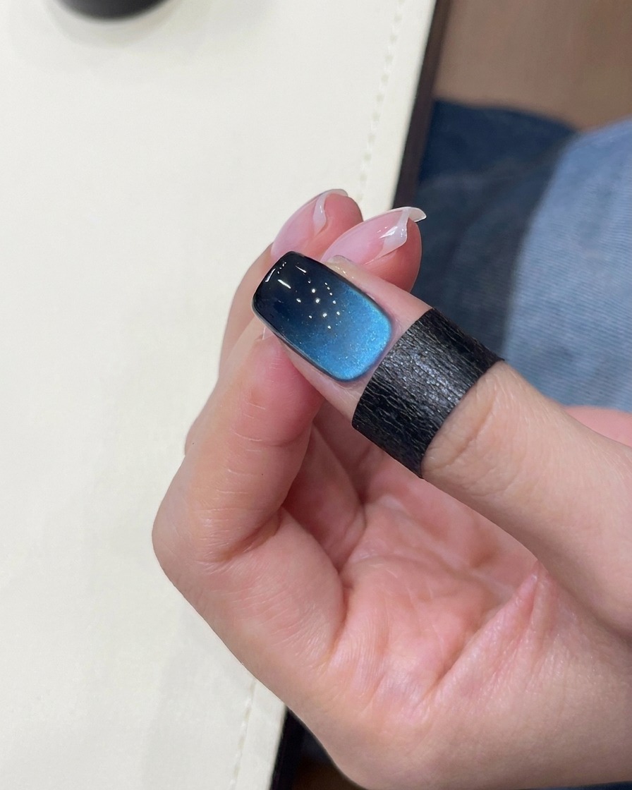 Un pennello che applica il gel nero sulla punta dellunghia.