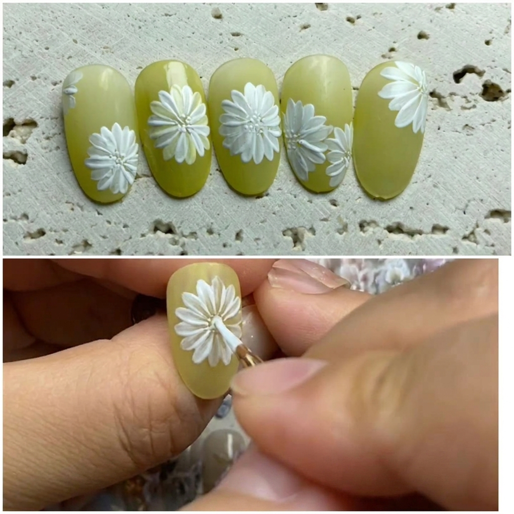 Ununghia decorata dove un pennello aggiunge petali bianchi tra quelli esistenti per completare il fiore.