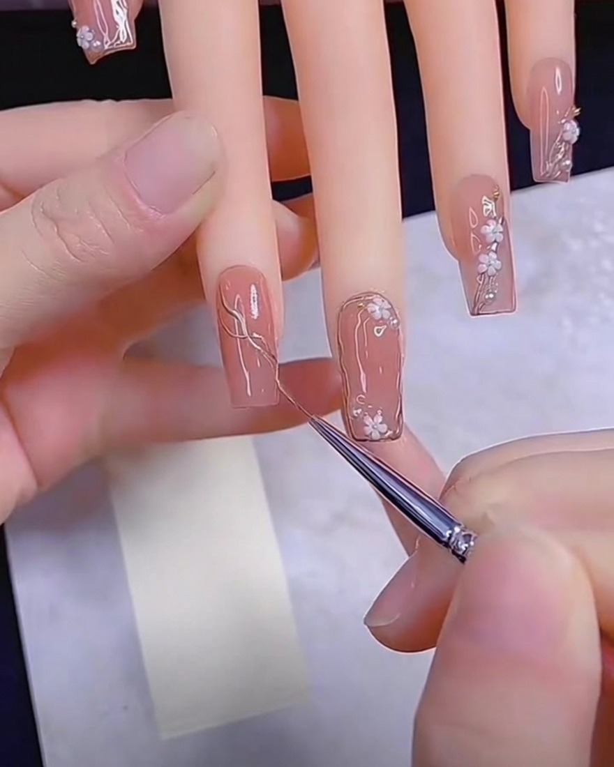 Un pennello di precisione applica gel metallizzato su ununghia nude.