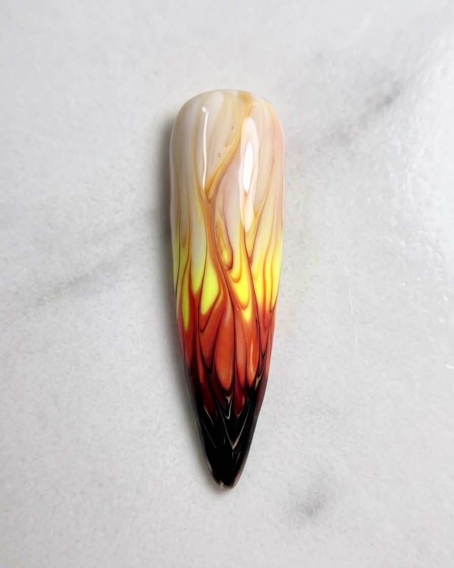 Vista dallalto del design della nail art con fiamme completato, perfettamente sfumato e pronto per il processo di polimerizzazione.