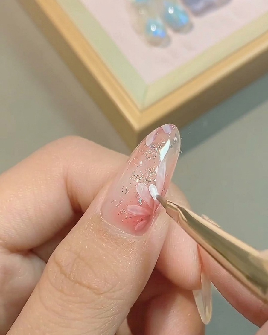 Un pennello liner sottile aggiunge un secondo strato di petali bianchi sopra il design iniziale.
