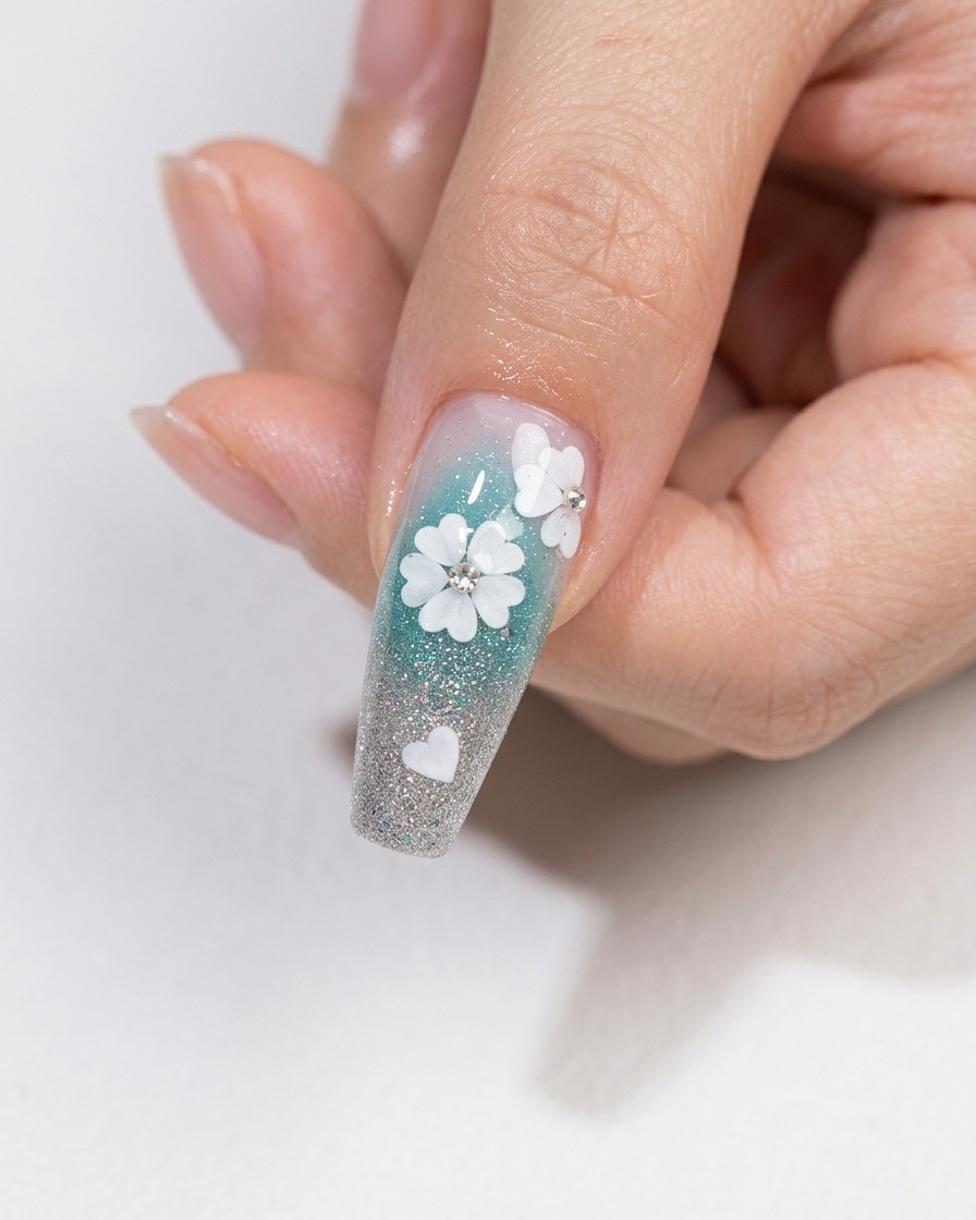 Un pennello per nail art che applica uno strato di top coat trasparente e lucido su un design floreale con cristalli incorporati.