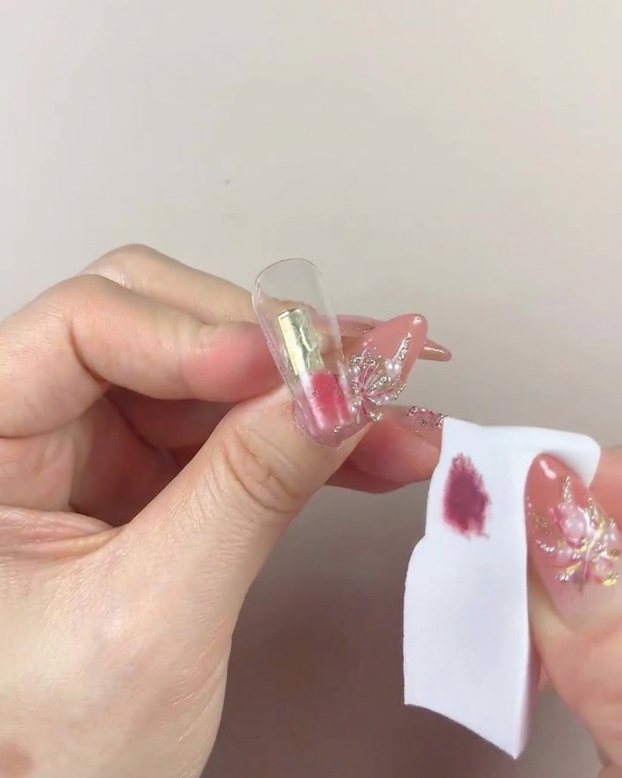 Primo piano della spugnetta che picchietta ripetutamente il gel sulla punta dellunghia.
