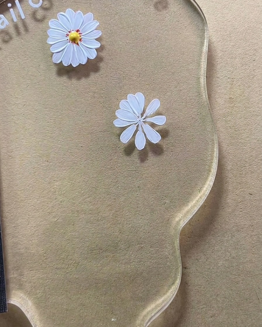 Un primo piano del disegno della margherita a otto petali ormai quasi completato sulla tavolozza.