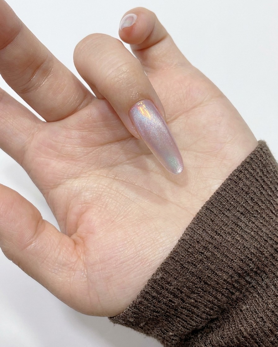 Un magnete cilindrico tenuto contro il lato dellunghia per attirare i riflessi magnetici.