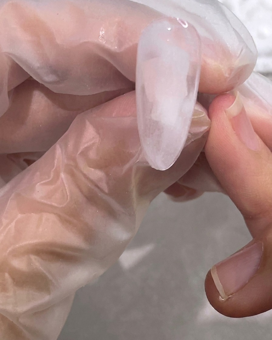 Un pennello sfuma il gel bianco nella base trasparente per creare un morbido effetto marmo nuvoloso.