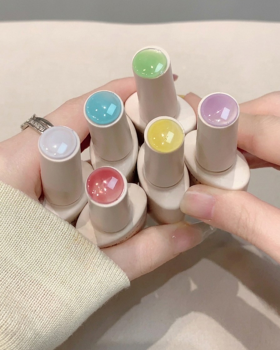 Un pennello che stende uno strato di top coat lucido trasparente sopra la nail art finita.