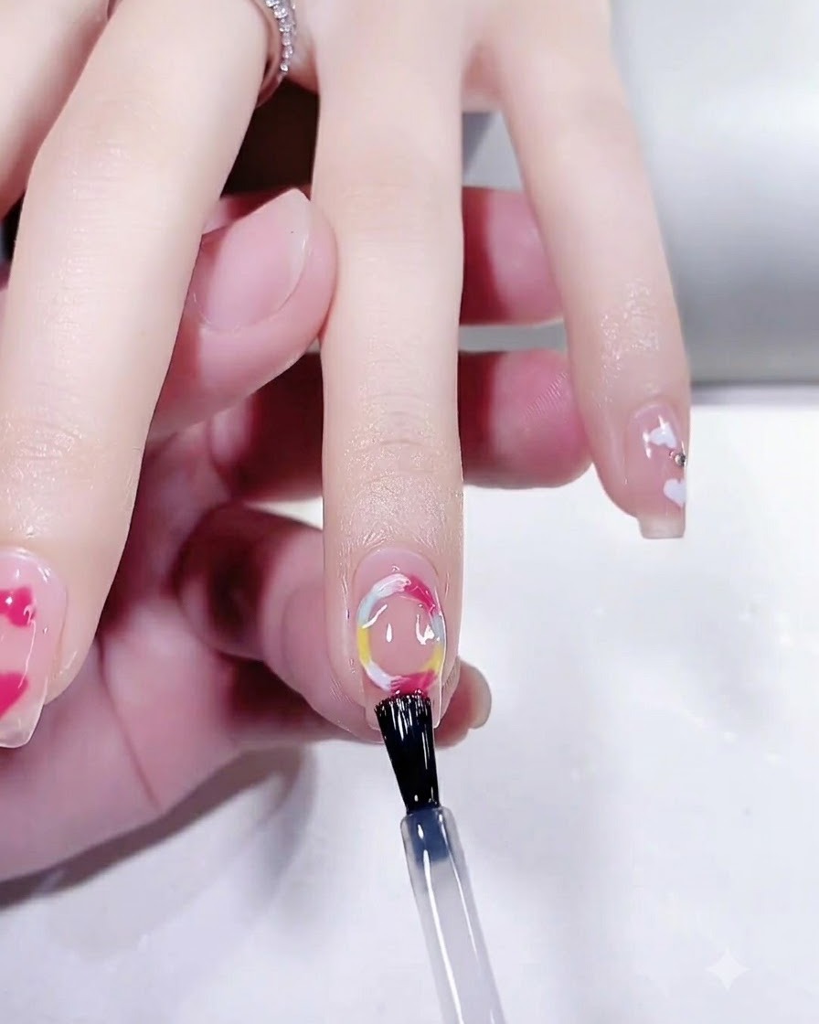 Una mano posizionata allinterno di una lampada per unghie UV LED che polimerizza il top coat finale di una manicure.