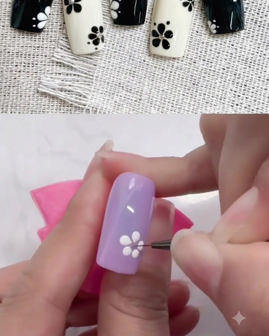 Un pennello liner sottile trascina punti di gel bianco verso linterno per modellare i petali su ununghia viola.