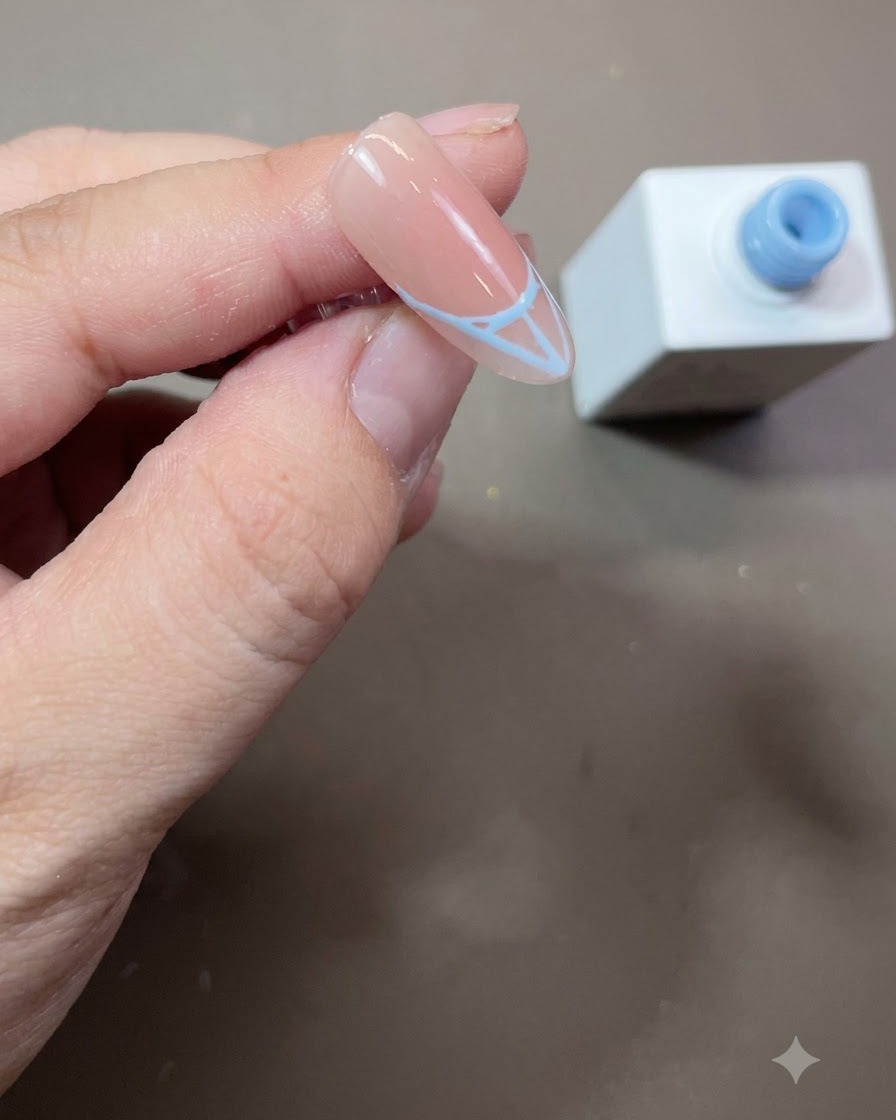 Un contorno French blu completato riempito solidamente con smalto gel blu su ununghia a mandorla.