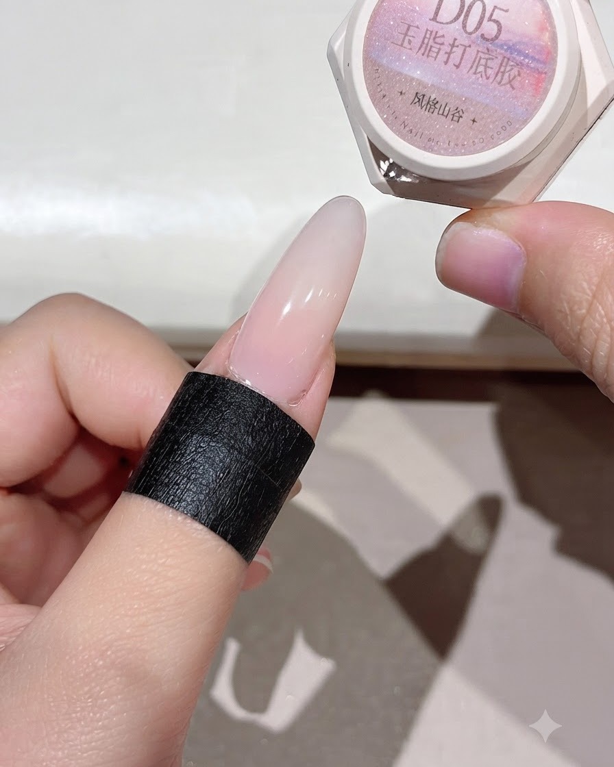 Ununghia polimerizzata che mostra uno strato di base rosato uniforme sotto la luce.