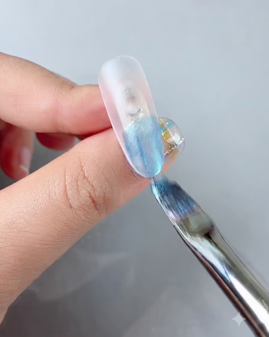 Un pennello per unghie che applica un gel colorato blu vibrante sulla punta di ununghia finta trasparente.