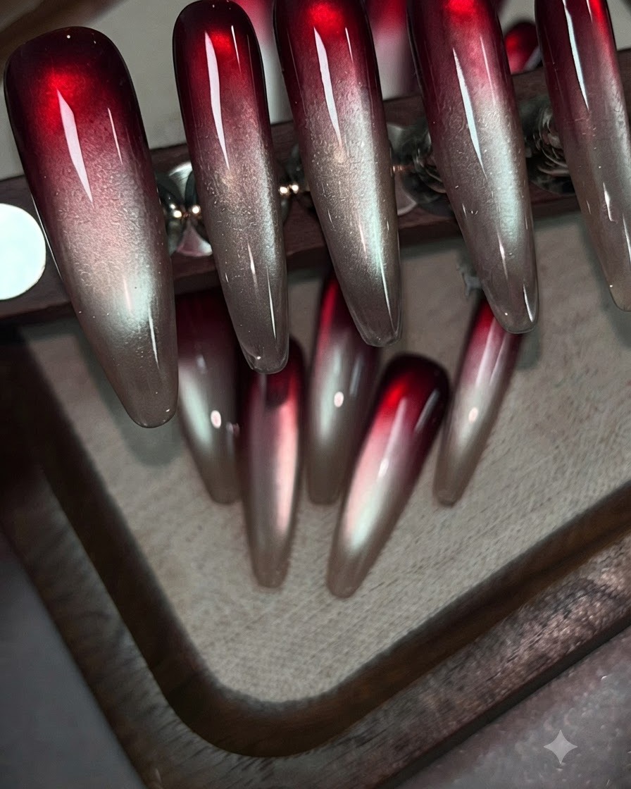 Un pennello applica il gel rosso vino sulla parte superiore di una tip per unghie trasparente di prova.