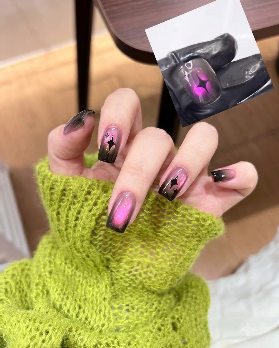 Un pennello da unghie applica una mano di smalto gel nero sheer su ununghia naturale.