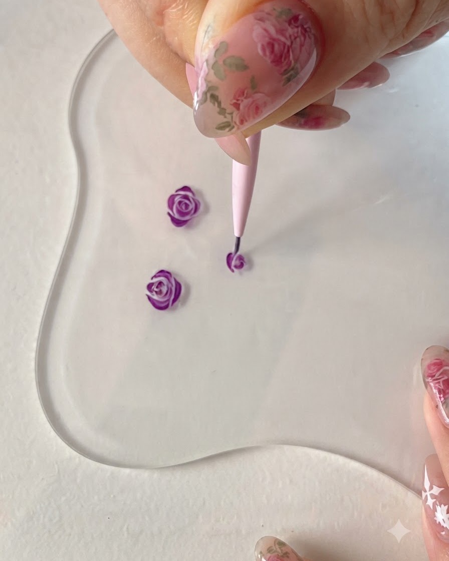 Un pennello liner fine che aggiunge linee di petali esterni fluttuanti per sviluppare ulteriormente la forma della rosa viola.