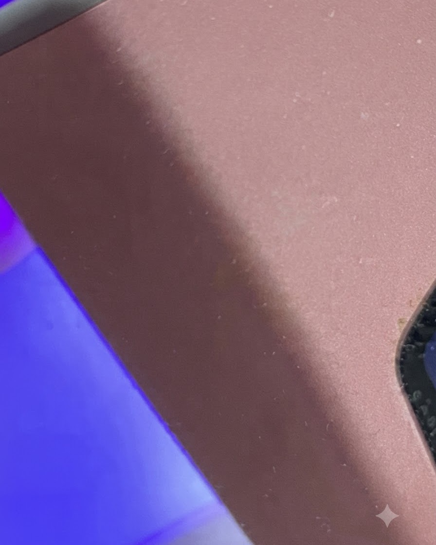 Dito posizionato sotto una mini lampada UV/LED a luce viola per la polimerizzazione.