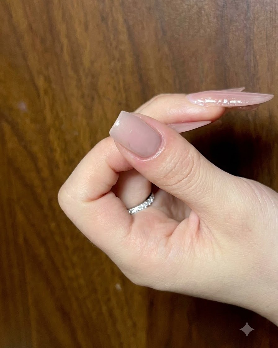 Un primo piano di ununghia manicure nude che riceve tratti dettagliati di gel cat-eye per larte delle ali di farfalla.