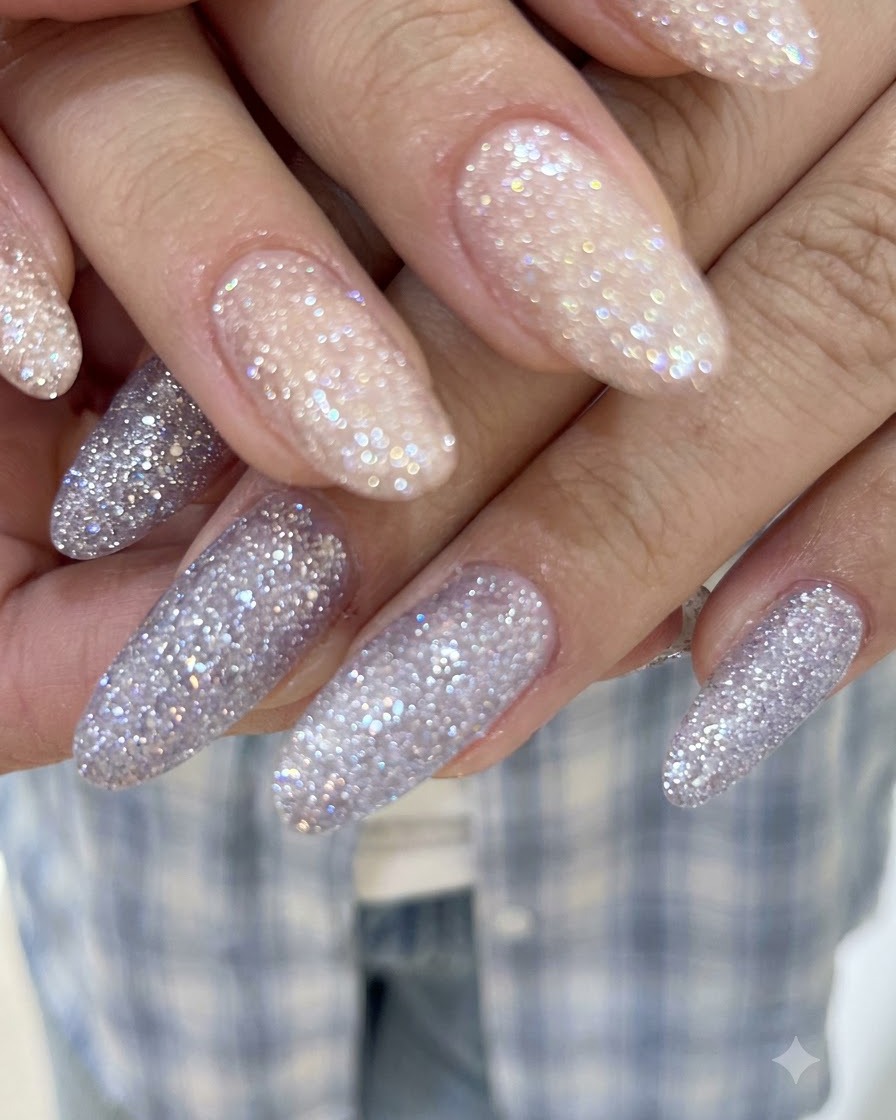 Primo piano dettagliato che mostra lo sparkle di cristalli traslucidi e la copertura uniforme di gel glitter su unghie lunghe.