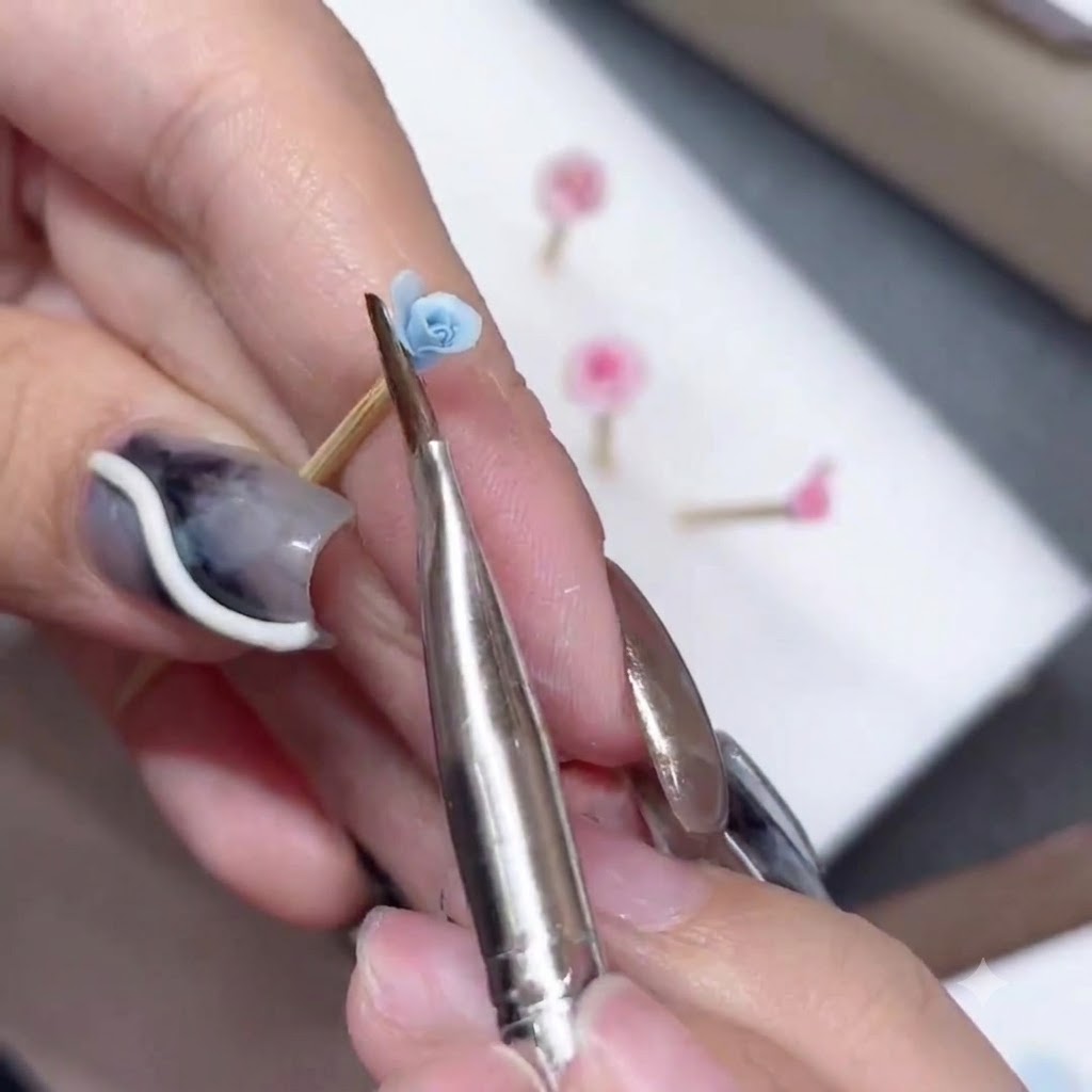 Un pennello in silicone che modella e allarga il bordo di un petalo di rosa blu.