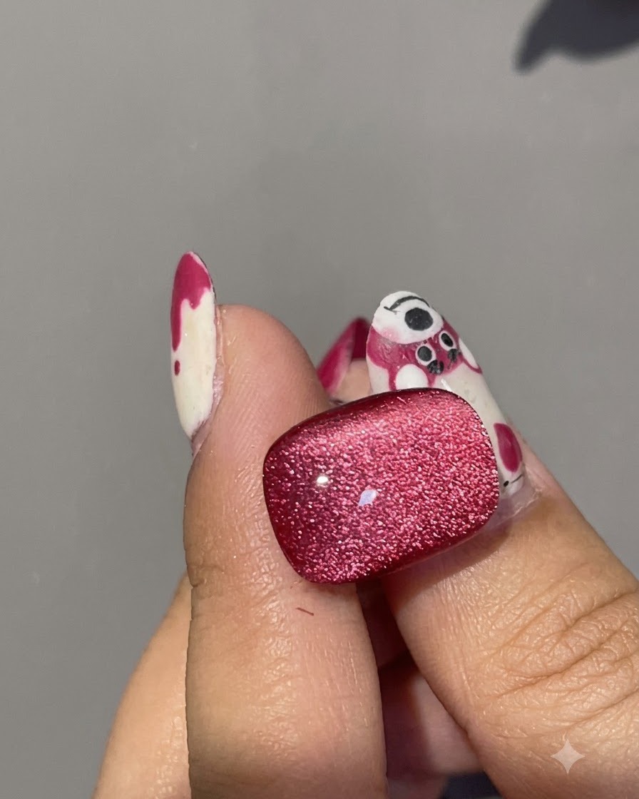 Primo piano di un magnete che perfeziona il riflesso inferiore sulla superficie di ununghia in gel cat eye rosso.