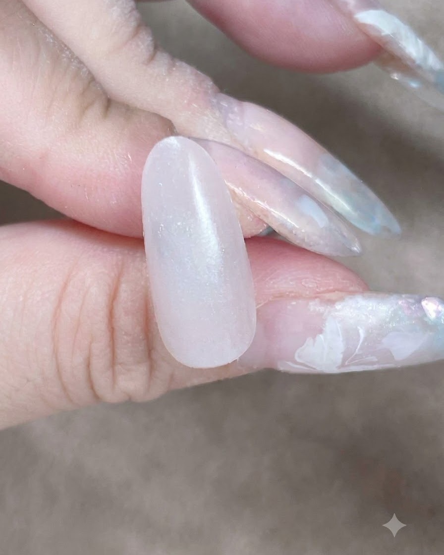 Primo piano di una spugnetta che tampona lungo la linea delle cuticole e il vallo laterale per sfumare lo strato di base in gel.