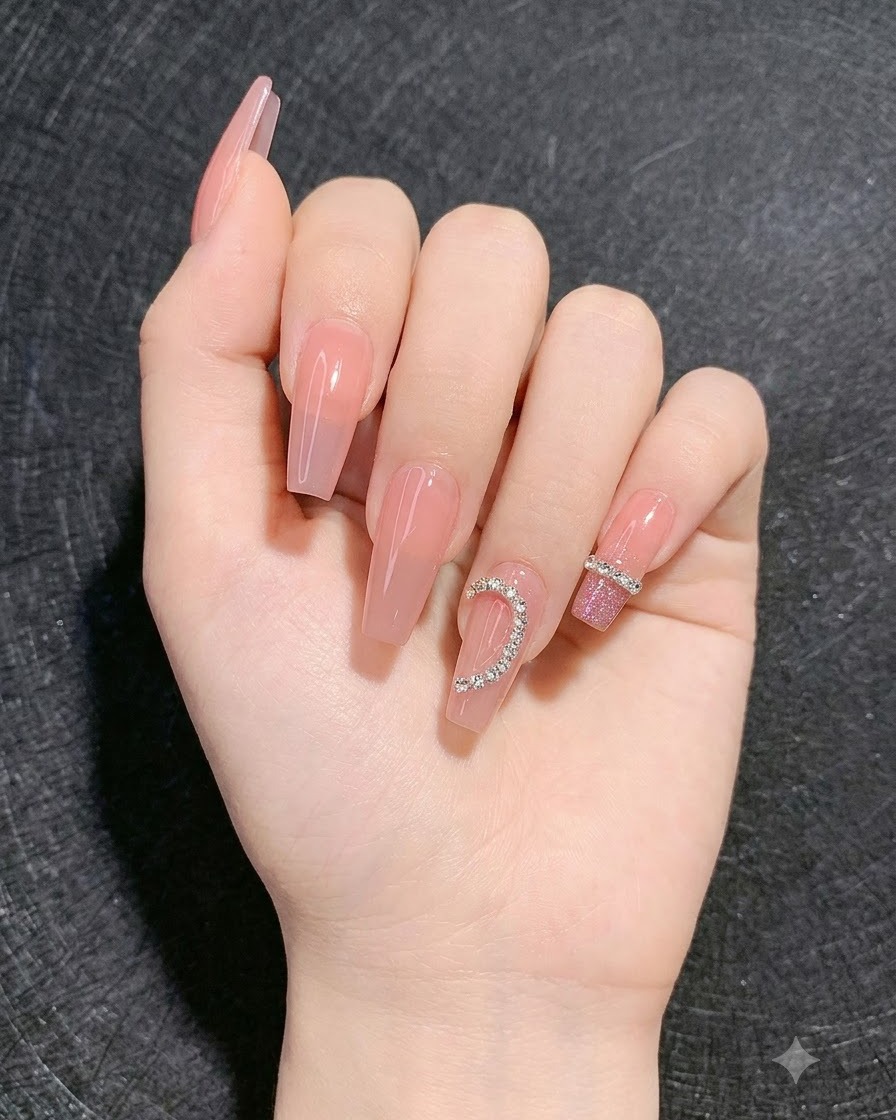 Una mano mostra le unghie completate con una sfumatura disco brillante sulle dita circostanti e un design di strass a cuore.