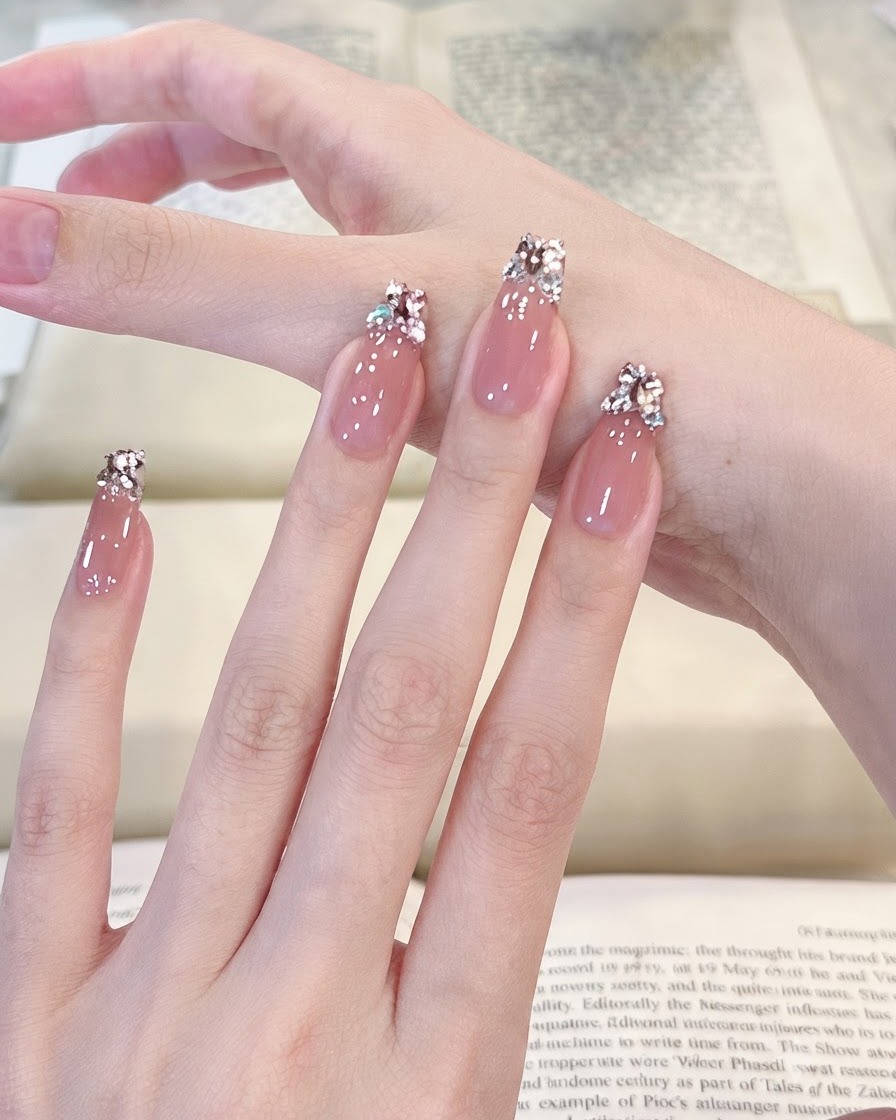 Una vista panoramica fluida su quattro dita con manicure che mostra una superficie in gel traslucido rosa chiaro e lucido.