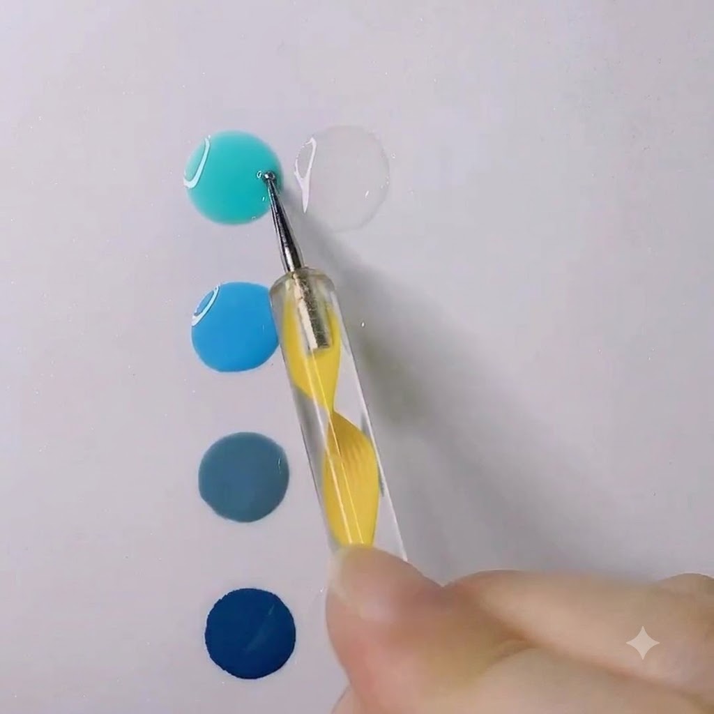 Un dotter che mescola una goccia di gel blu acqua brillante in una goccia di gel trasparente su una superficie bianca.