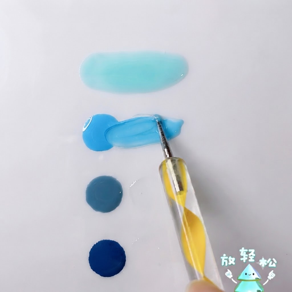 Un dotter che mescola il gel blu cielo brillante con il gel trasparente su una tavolozza bianca.