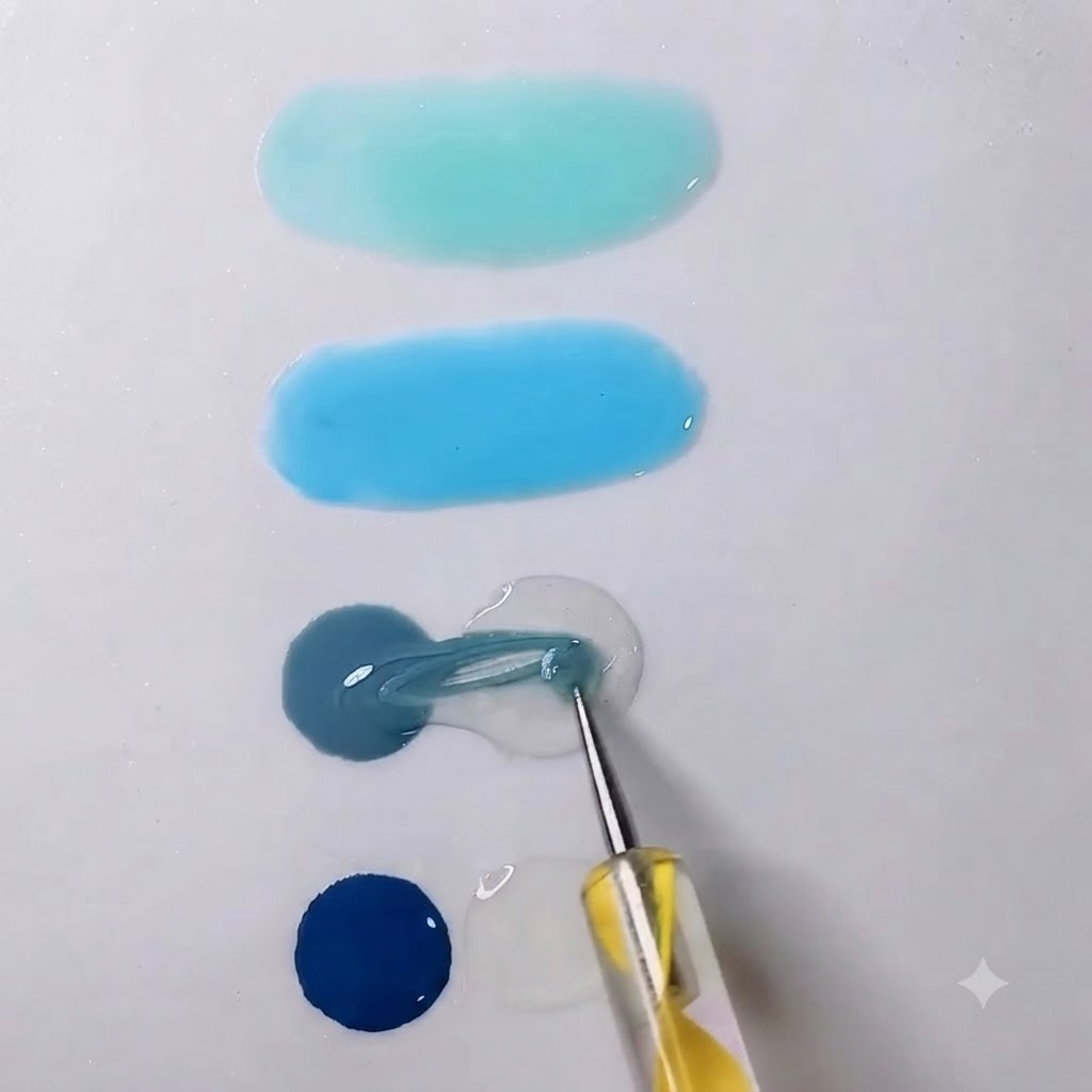 Uno strumento di miscelazione che trascina il gel grigio in una vicina goccia di gel trasparente su una tavolozza bianca.